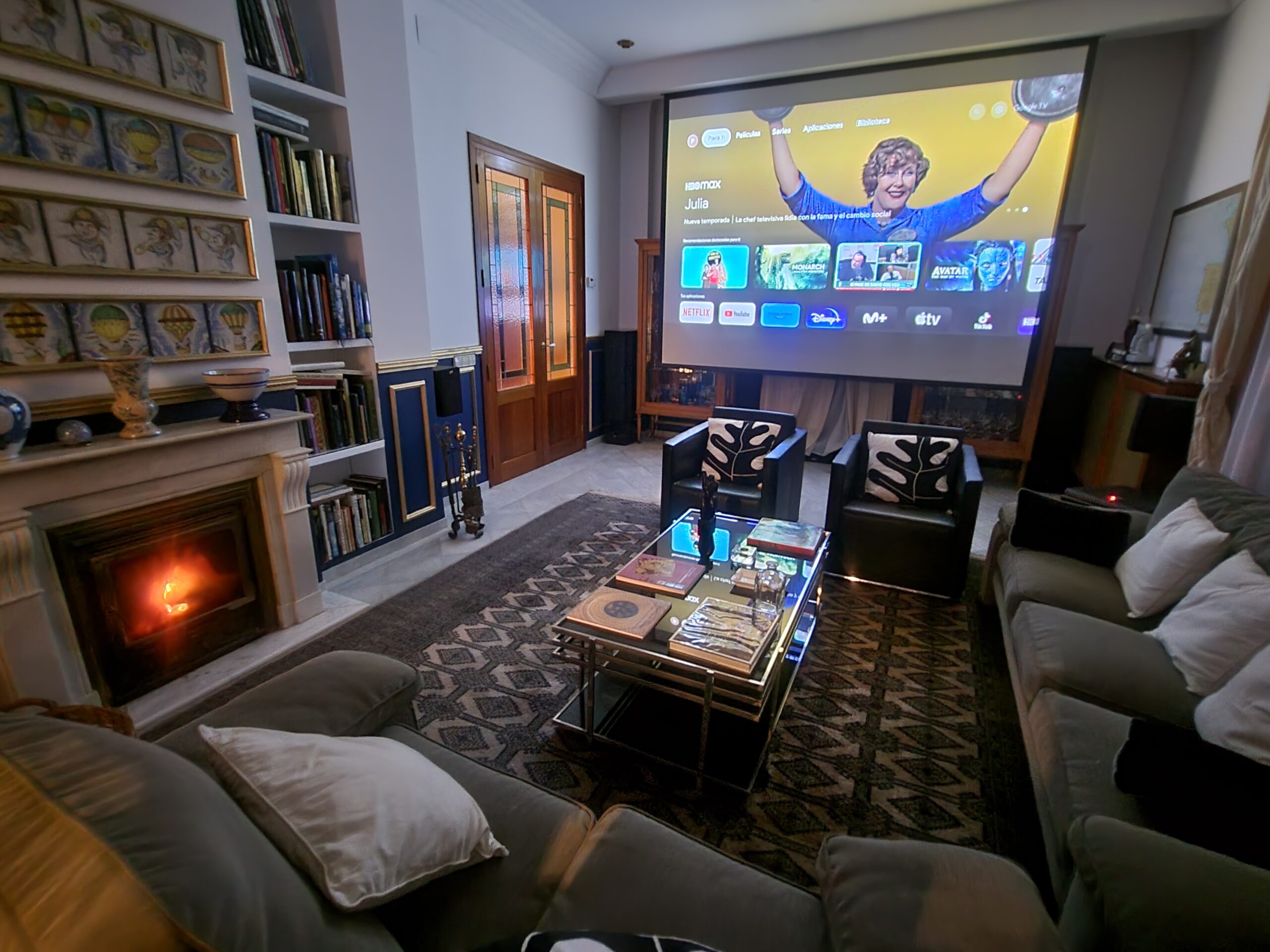Sala de cine con la chimenea encendida en Villa Paula